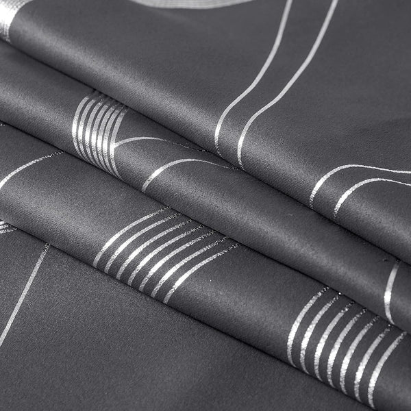 Dark grey fabric with shimmering silver geometric stripes and elegant curved lines, shown folded.