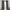 Dark grey textured pleated curtains on wooden rod. Lighter grey lining visible.