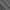 Close-up of a dark grey blackout fabric sample, showing its smooth front and stitched reverse side.