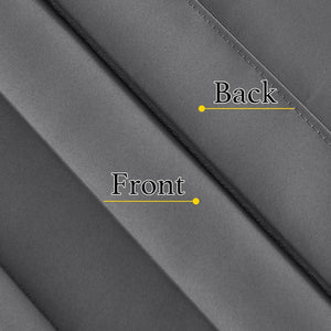 Close-up of a dark grey blackout fabric sample, showing its smooth front and stitched reverse side.