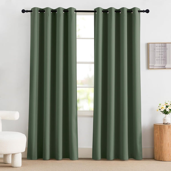 Pair of dark olive green grommet top curtains hanging on a black rod in a modern room.