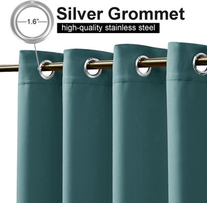 Close-up of dark teal blackout curtains with 1.6 inch silver grommets hanging on a golden rod.