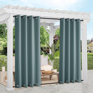 Dark teal outdoor curtains with grommet tops on a white pergola, providing privacy for a patio seating area.