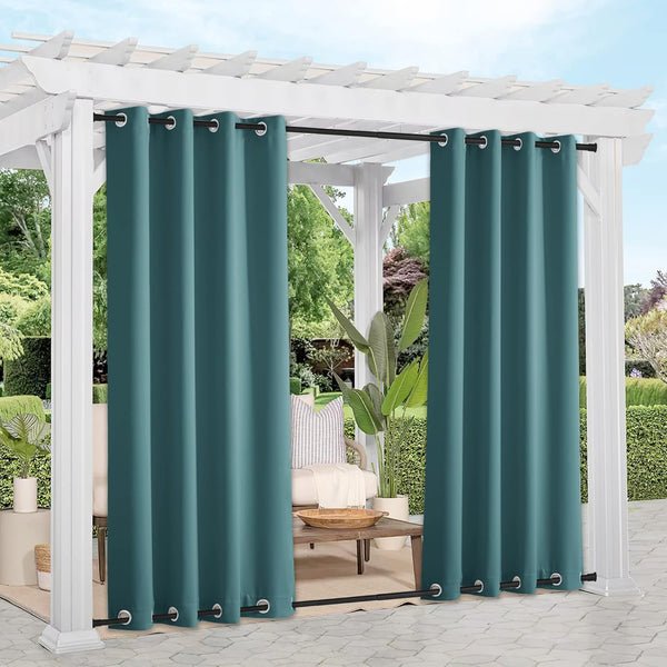 Dark teal outdoor grommet curtains on a black rod, offering privacy under a white pergola on a patio.