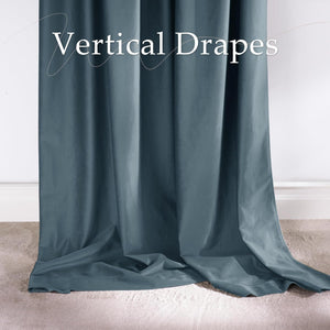 Close-up of a dark teal velvet vertical drape hanging with elegant folds to the floor over light carpet.