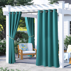 Dark turquoise outdoor grommet curtains on a white pergola. One panel tied back, enhancing patio privacy.