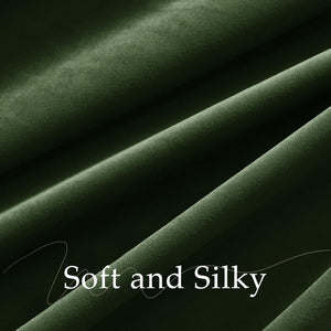 Close-up of deep forest green velvet fabric, highlighting its soft, silky texture and elegant folds.