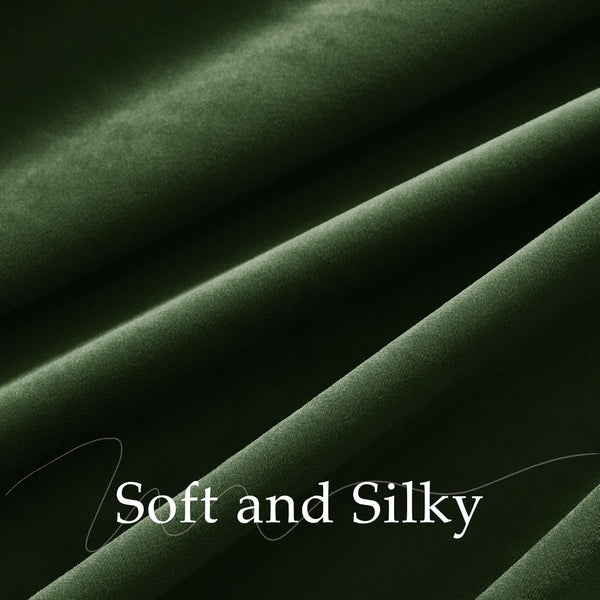 Close-up of deep forest green velvet fabric, highlighting its soft, silky texture and elegant folds.