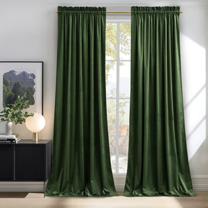 Deep green velvet rod pocket curtains hanging on a gold rod over a window.