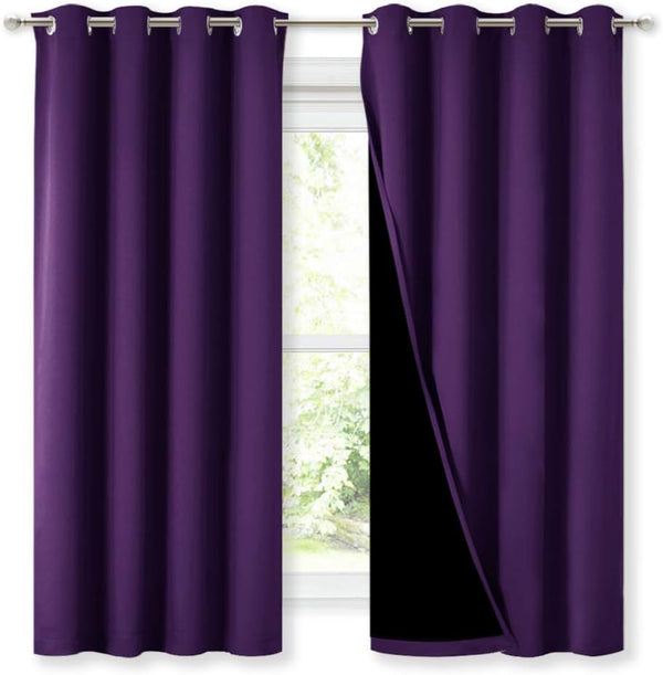 Deep purple blackout curtain pair with silver grommets. One panel reveals black lining.