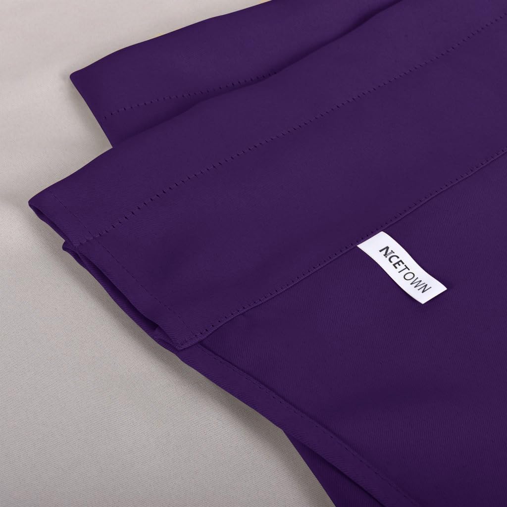 Close-up of a smooth deep purple blackout curtain fabric with a visible white NICETOWN label and fine stitching.