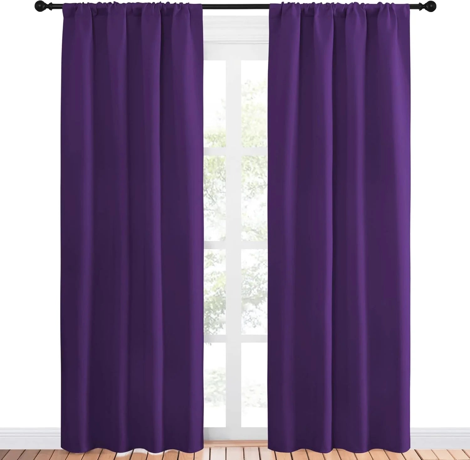 Pair of deep purple rod pocket curtains hanging on a black rod over a window.