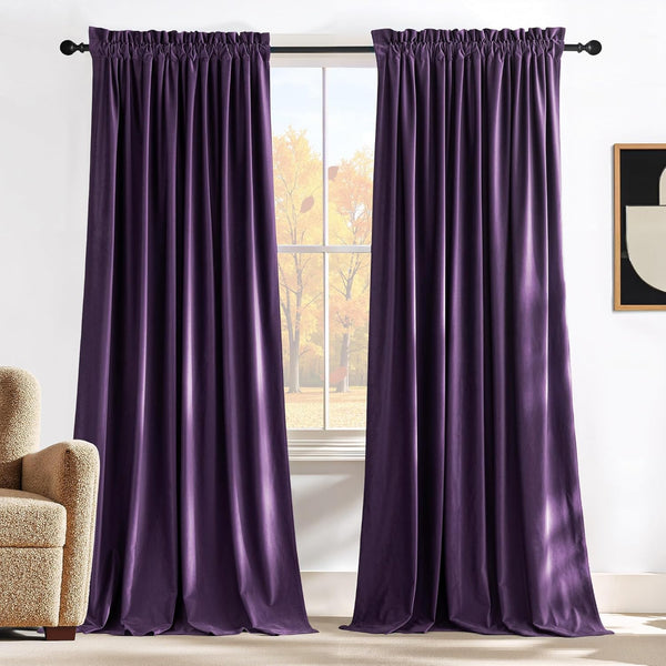 Deep purple velvet curtains with a gathered rod pocket top, hanging from a black rod in a cozy room.