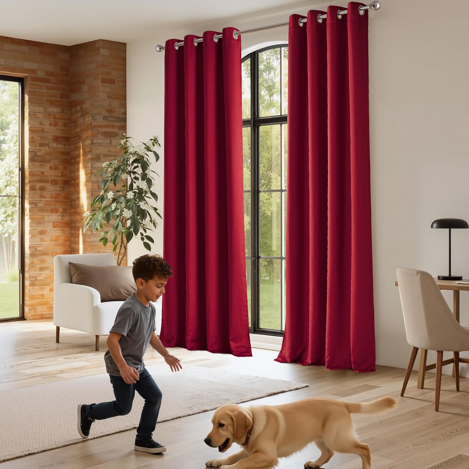 Deep red grommet top curtains with silver rings elegantly cover large windows in a modern living room.