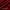 Close-up view of deep red velvet fabric with soft, plush texture and gentle folds.