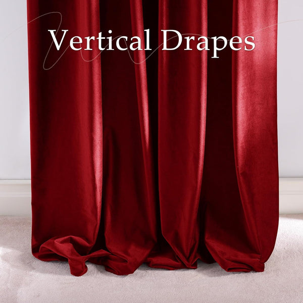 Rich deep red velvet drapes hanging vertically, pooling slightly on a light carpet.