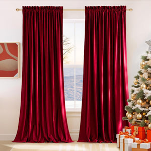 Deep red velvet curtains with pleated tops hang on a gold rod, framing a window. Luxurious and full-length drapes.