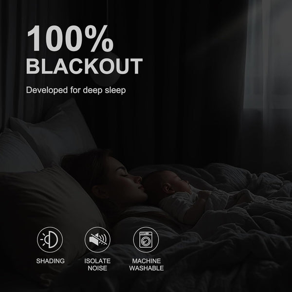 Mother and baby sleeping in a dark bedroom, illustrating the effectiveness of blackout curtains.