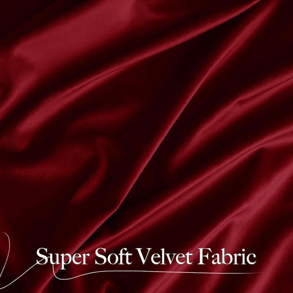 Draped burgundy velvet fabric exhibiting a soft, plush texture with a subtle sheen.