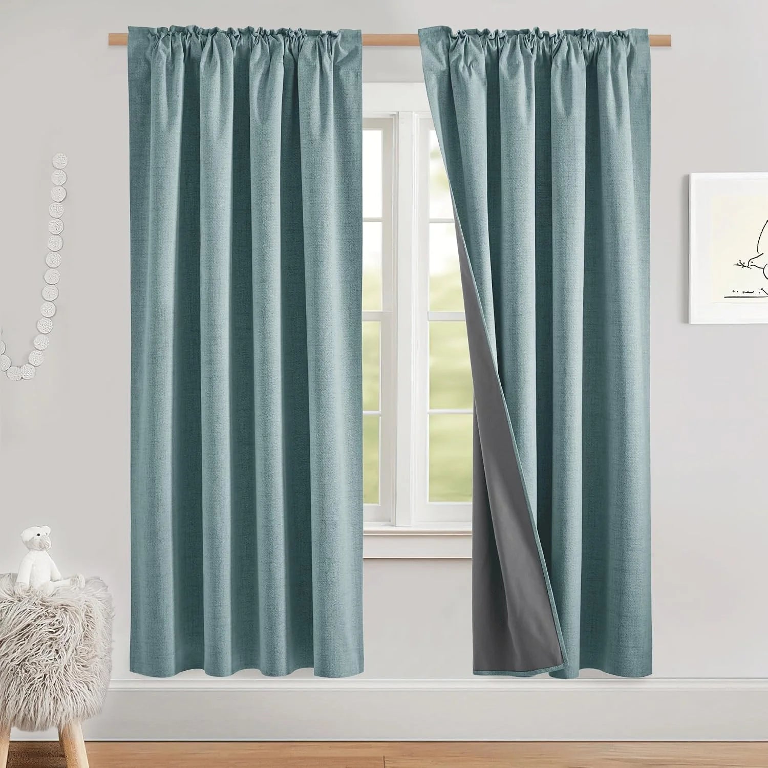 Duck egg blue blackout curtains with pencil pleat header hanging on a wooden pole