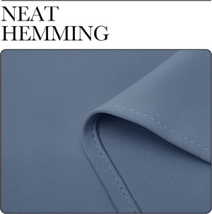 Close-up of dusty blue fabric with a smooth, fine weave, showcasing neat, consistent hemming.