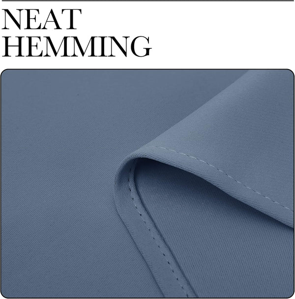 Close-up of dusty blue fabric with a smooth, fine weave, showcasing neat, consistent hemming.