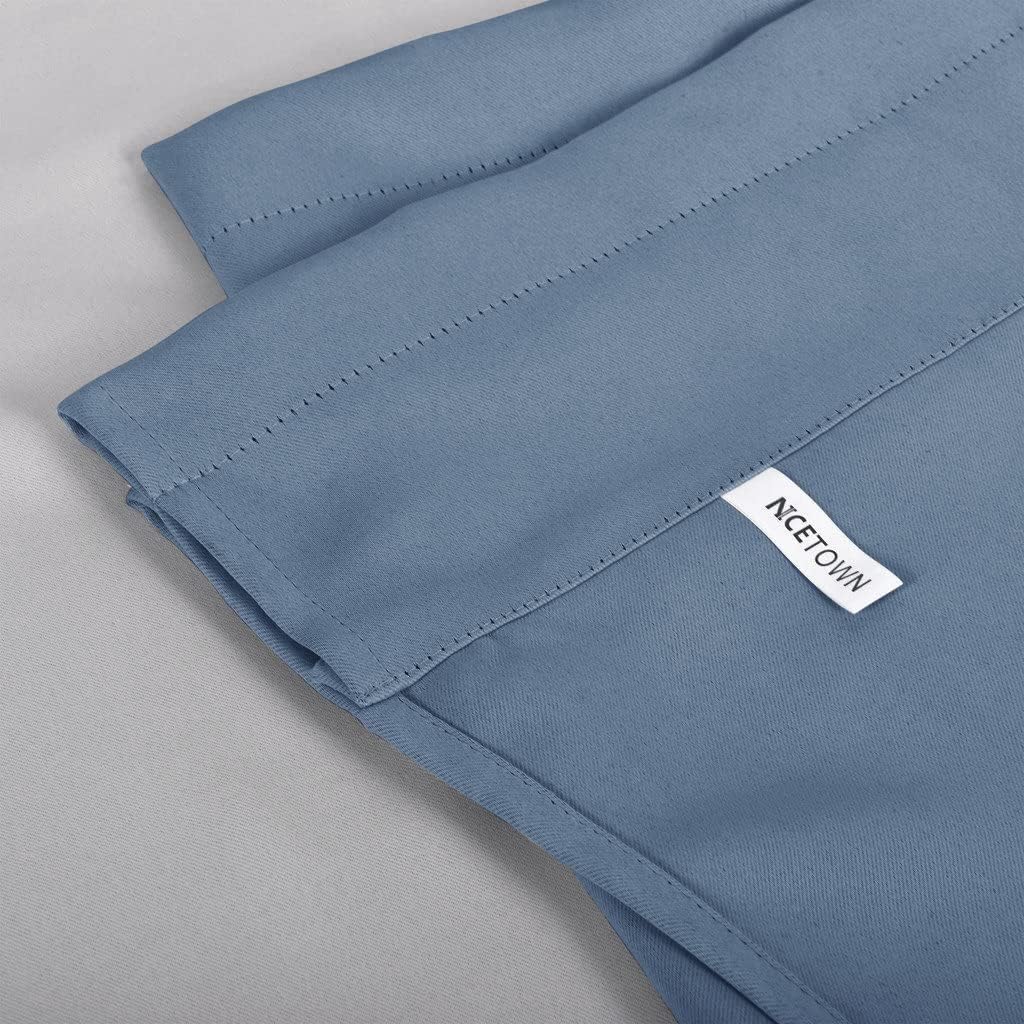 Close-up of a dusty blue NCEtown blackout curtain panel with visible top stitching.