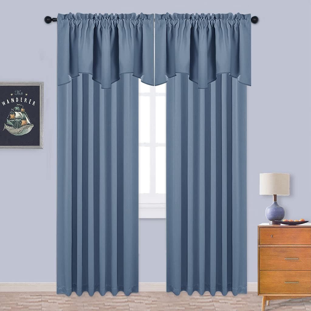 Dusty blue rod pocket curtains with an attached valance elegantly hang over a bright window.