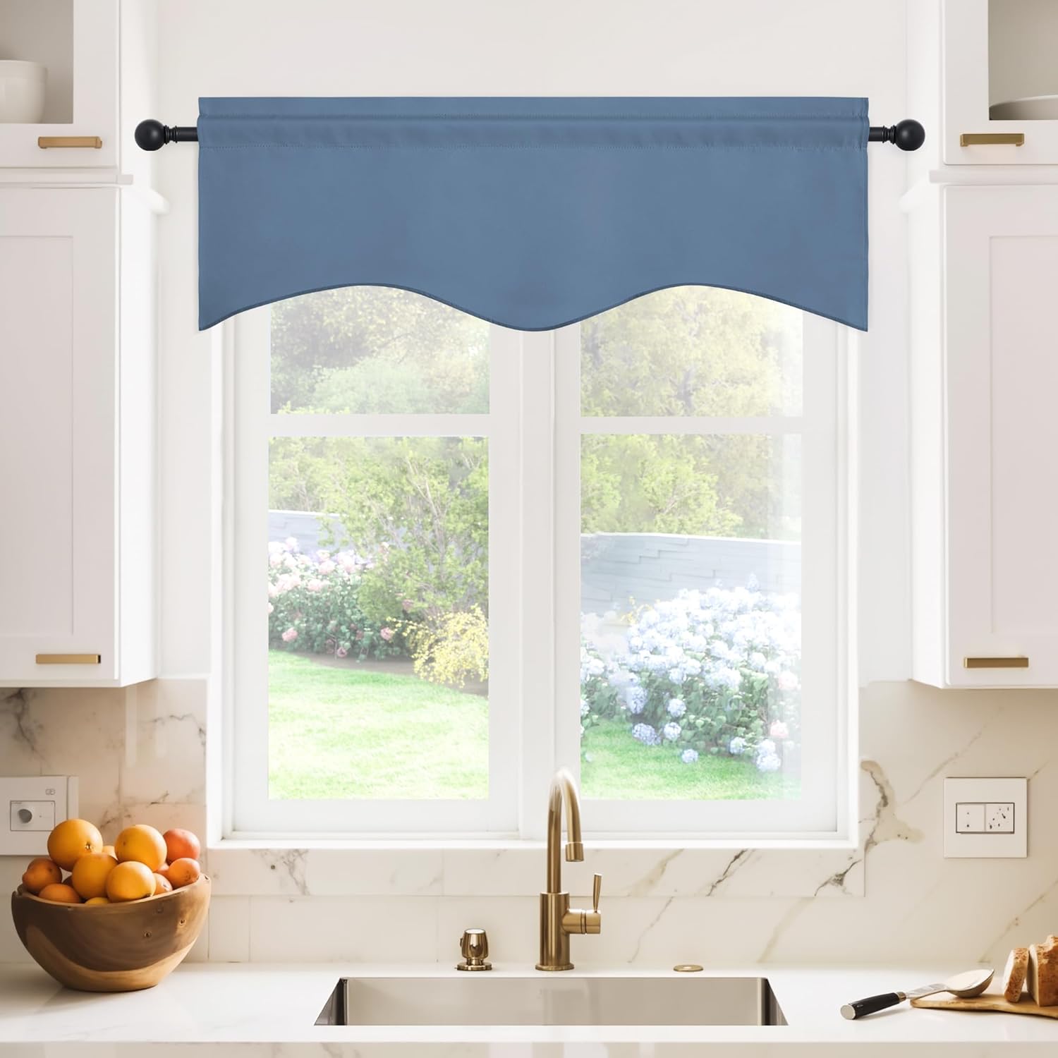 Tailored dusty blue window valance featuring a scalloped bottom border, mounted above a kitchen sink.