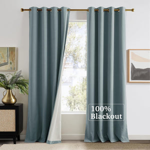 Dusty blue velvet texture blackout curtains with metal grommets, one panel open showing white lining.
