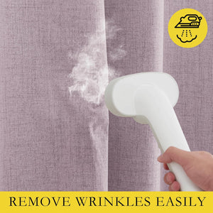 Dusty pink linen-textured curtains being steamed, highlighting easy wrinkle removal.