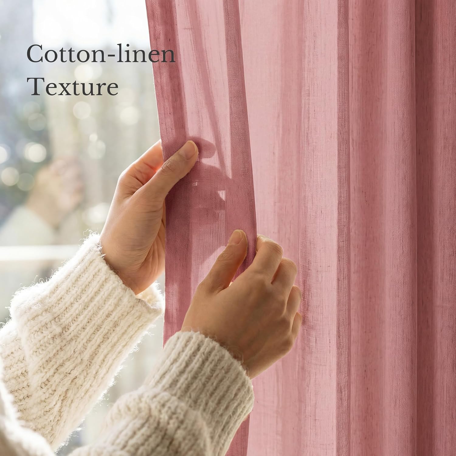 Dusty rose cotton-linen sheer curtain. A hand pulls it back, showcasing its natural textured weave.