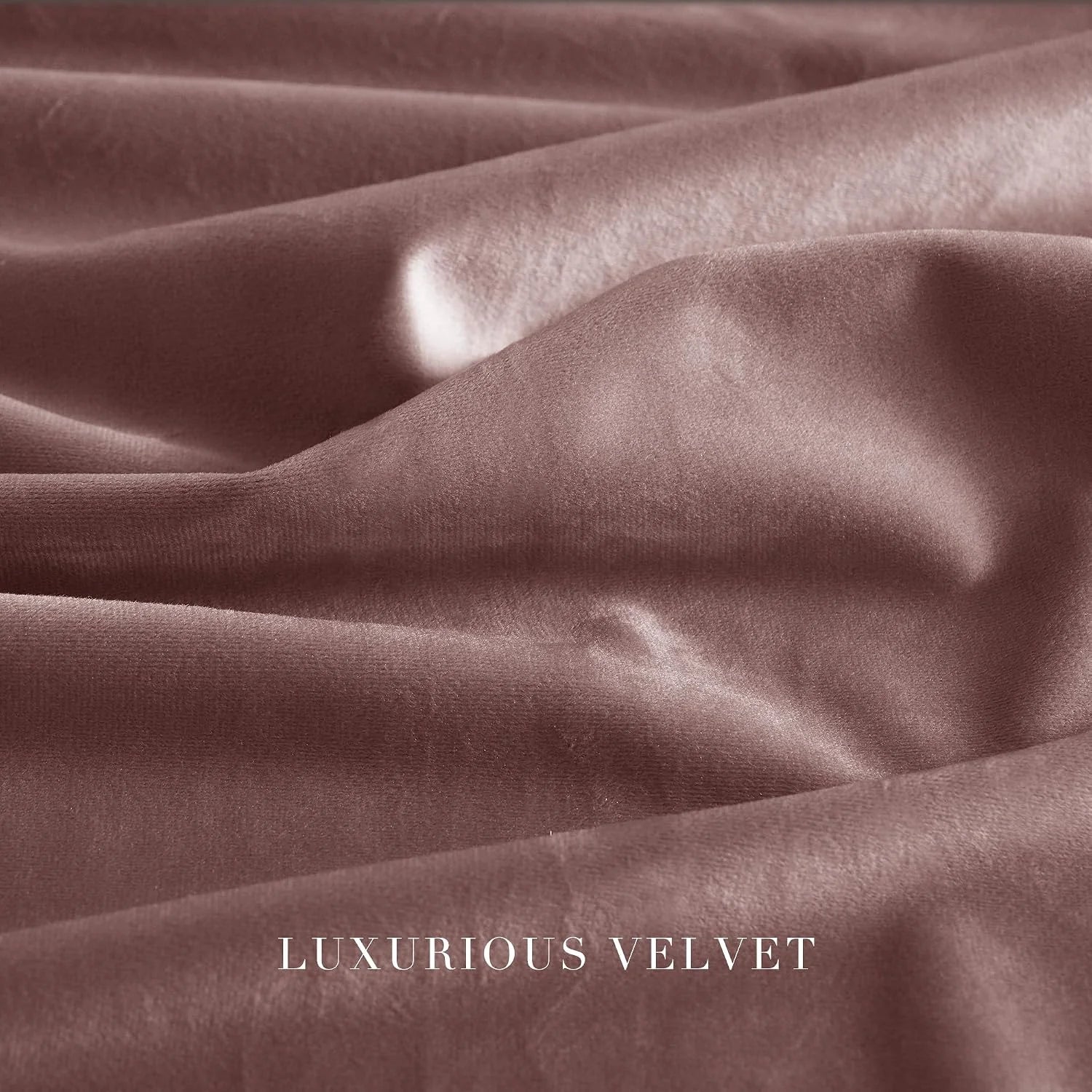 Close-up of dusty rose velvet fabric with soft sheen and elegant folds