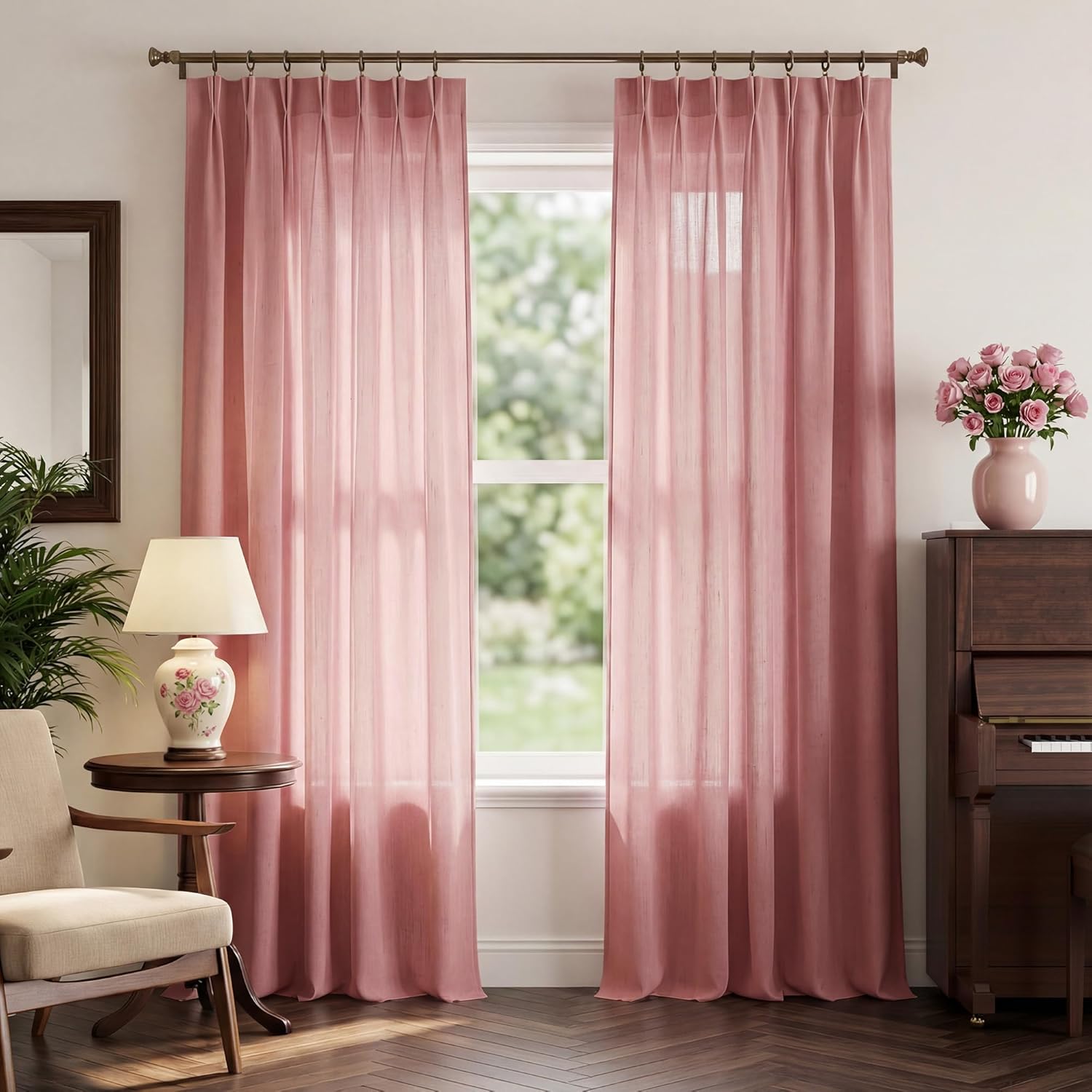 Dusty rose light filtering curtains with tailored pleats on a decorative rod, softening sunlight in a room.