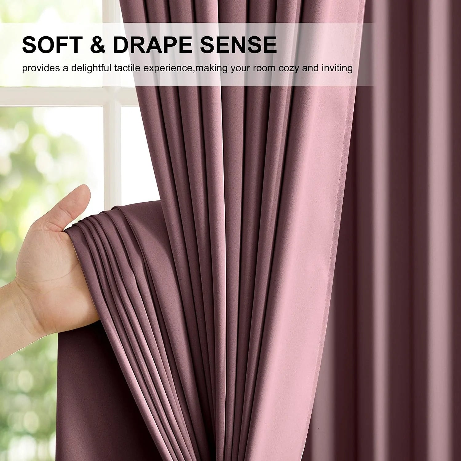 Hand holding dusty rose curtain panel to show soft drape and smooth fabric texture