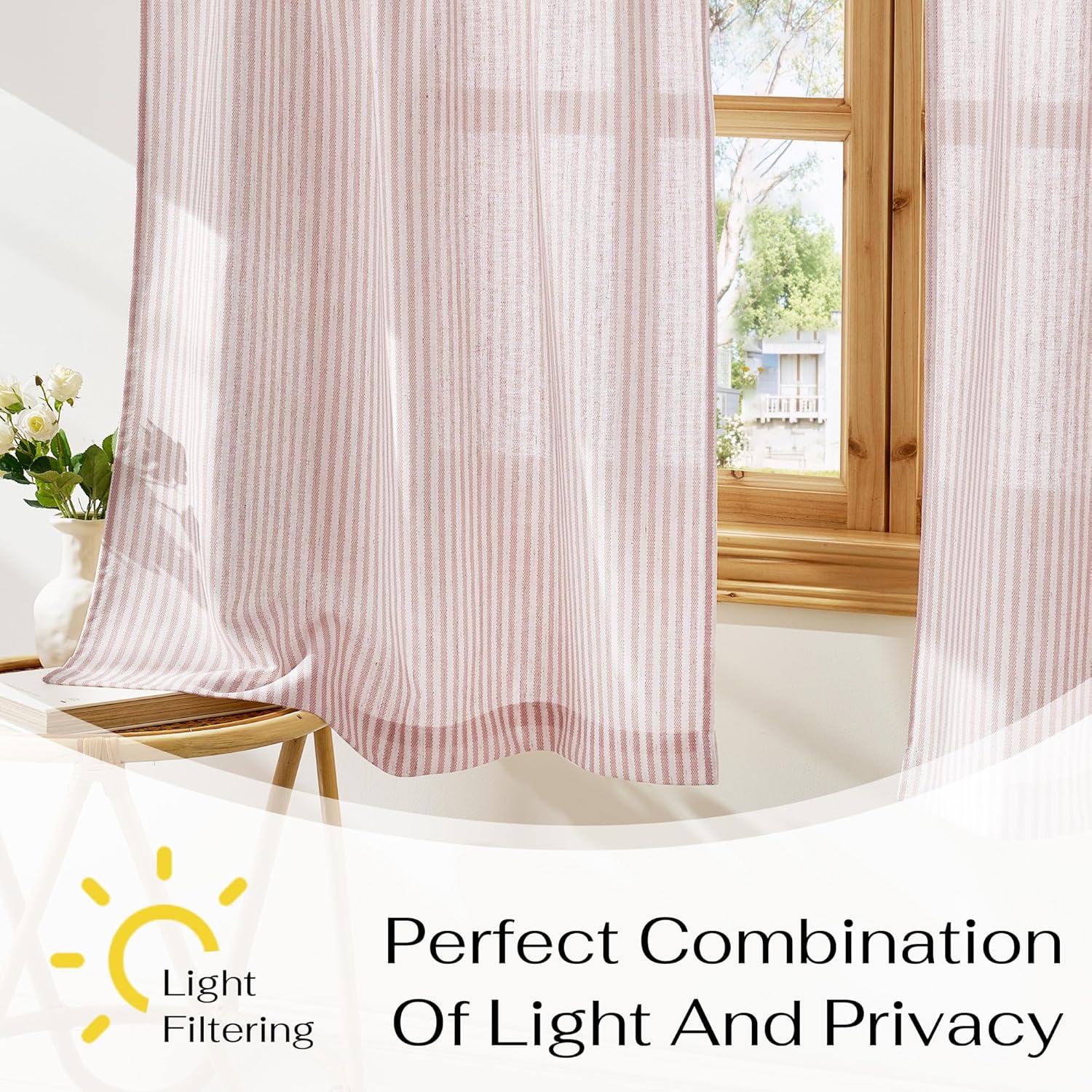 Dusty rose and white vertical striped light filtering curtains hanging on a wooden window frame.