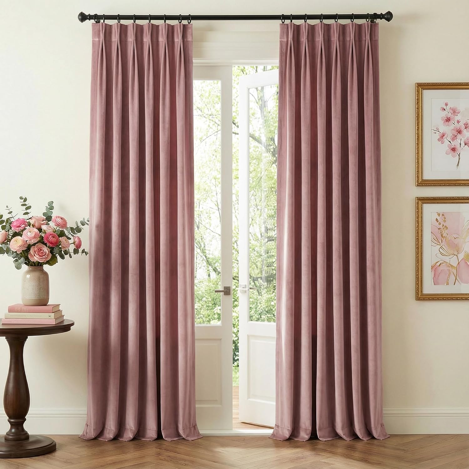 Elegant dusty rose velvet pinch pleat drapes hanging on a black rod, framing a bright doorway.