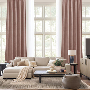 Elegant dusty rose velvet pleated drapes provide rich color and privacy in a contemporary living room setting.