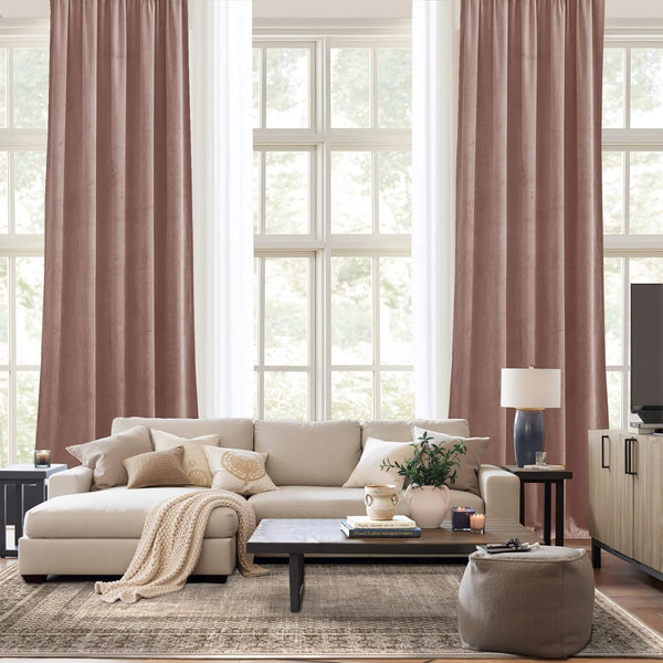 Elegant dusty rose velvet pleated drapes provide rich color and privacy in a contemporary living room setting.
