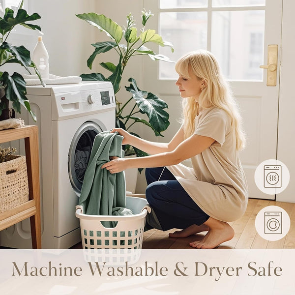 Woman puts soft green fabric into washer. Icons highlight machine washable and dryer safe.