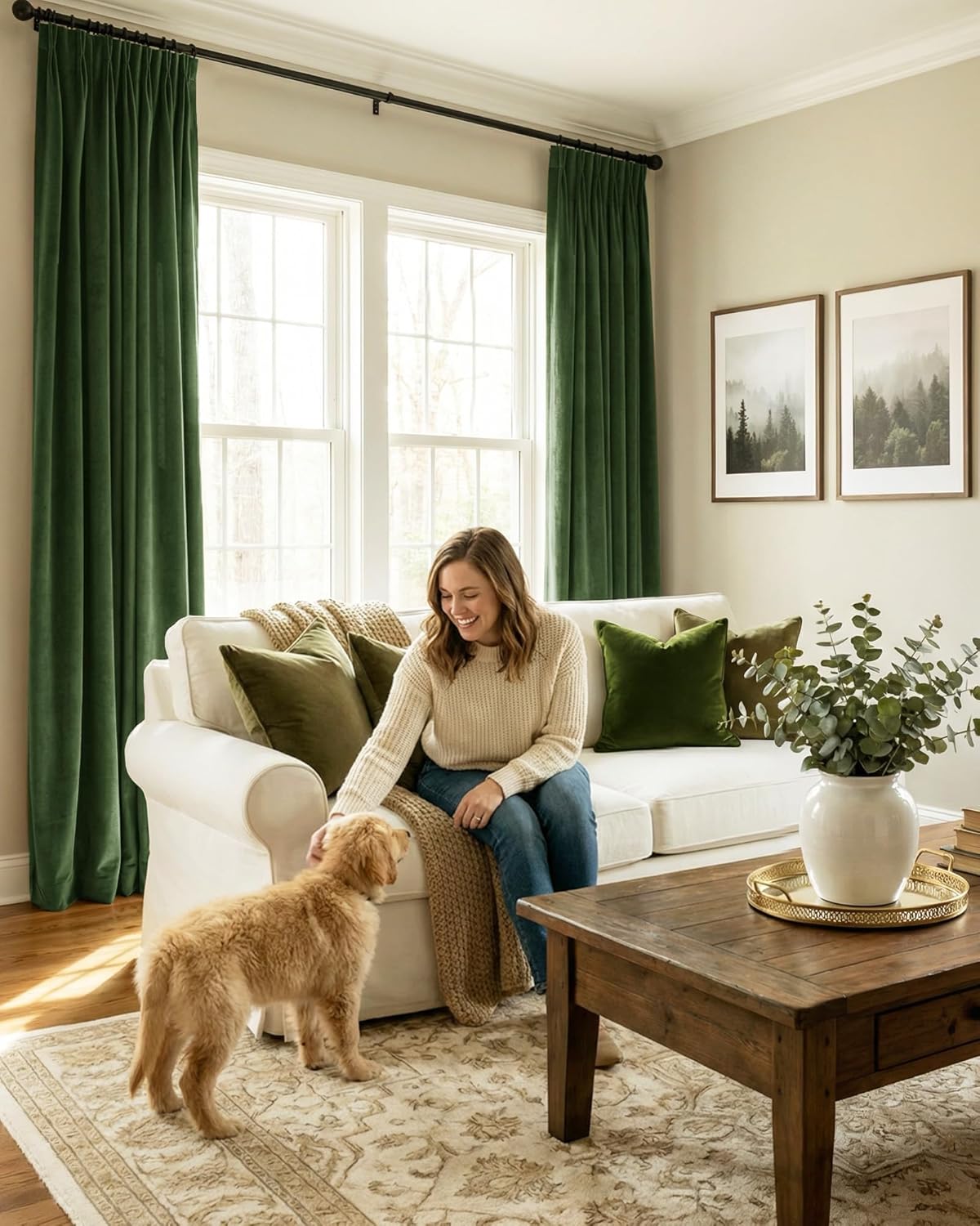 Emerald green velvet pleated curtains hanging on a black rod in a bright living room, adding luxurious texture.
