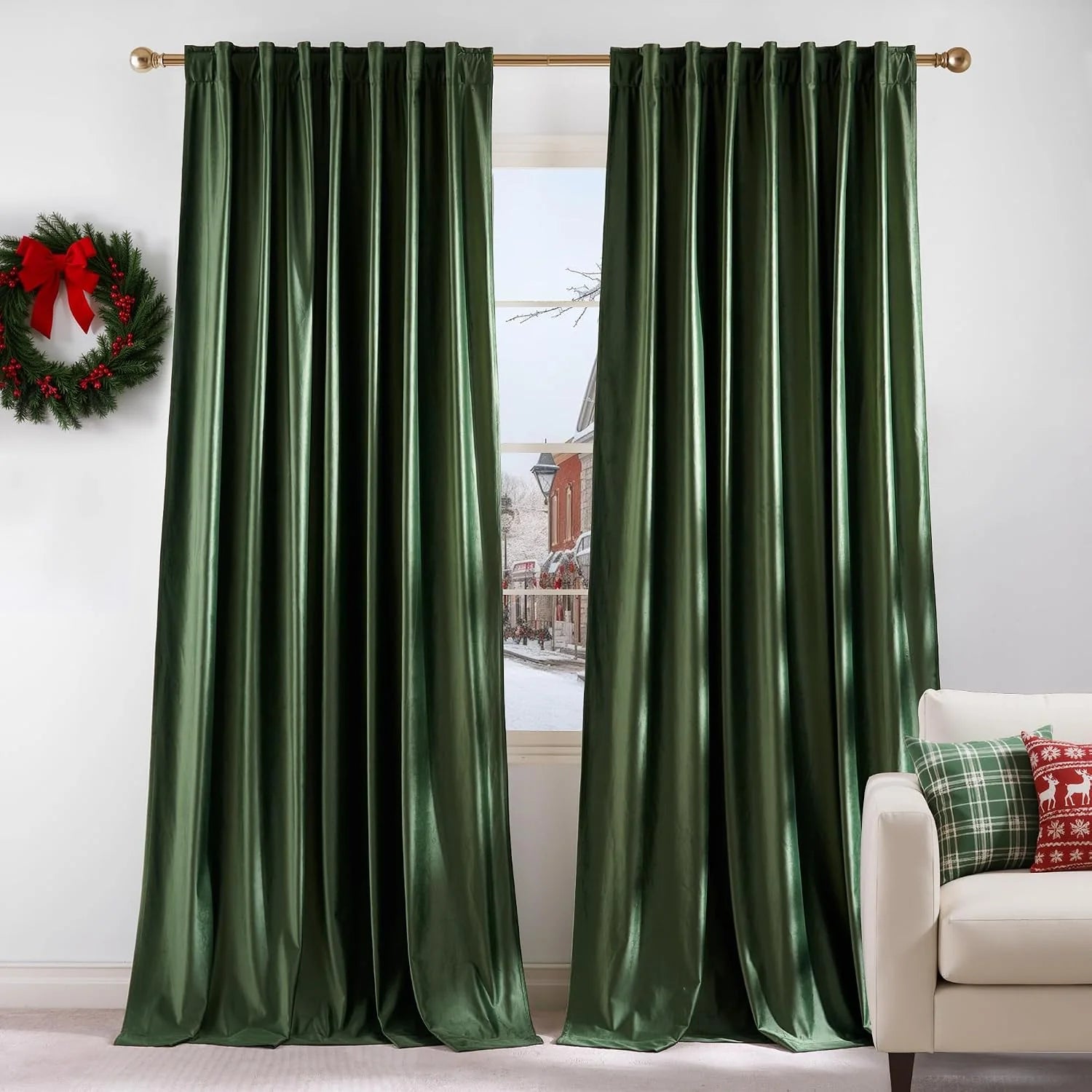 Emerald green satin curtains on a gold rod in a bright living room with holiday decor