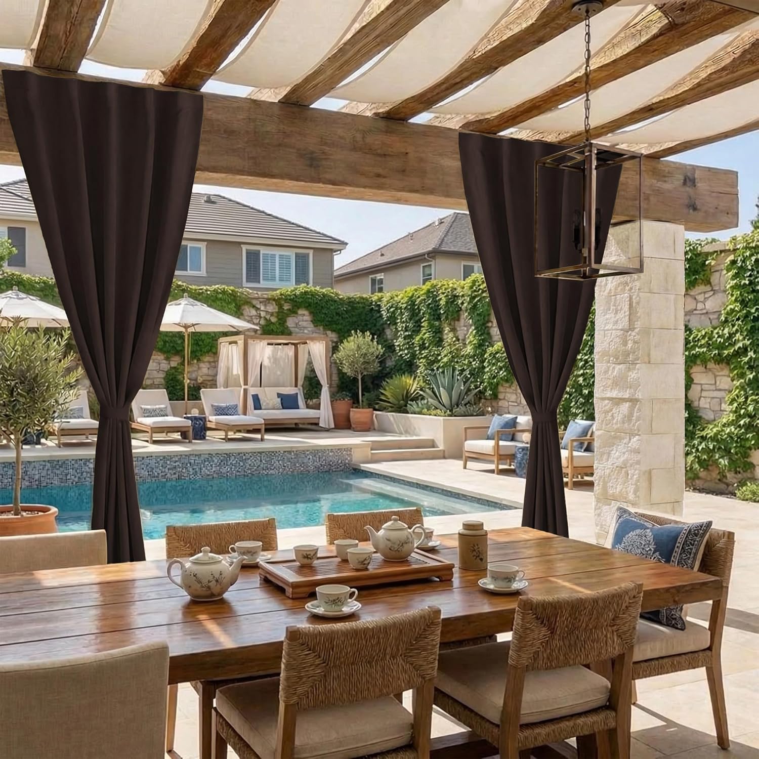 Espresso brown pleated outdoor curtains tied back on a wooden pergola, framing a luxurious poolside patio.