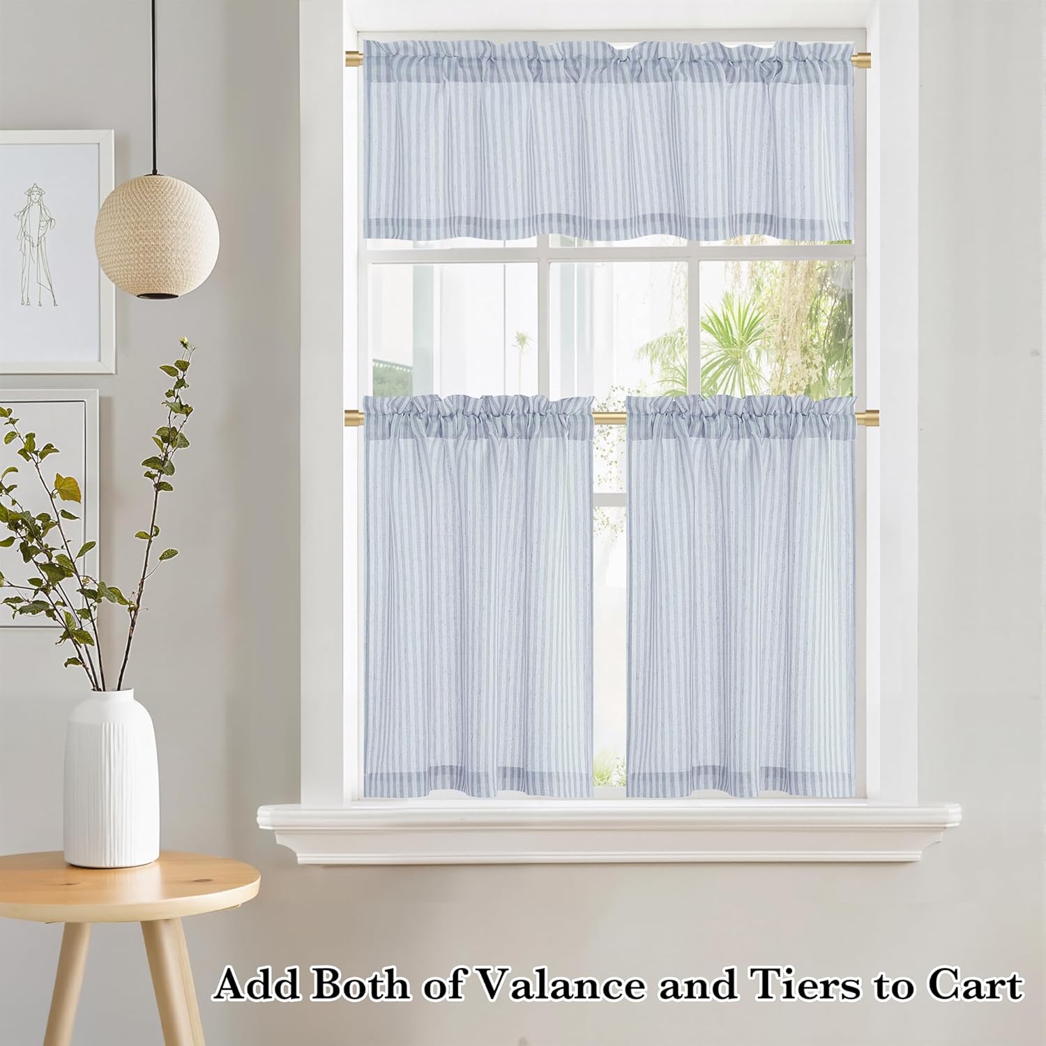 Light blue and white striped valance and tier curtains with a rod pocket top on a window.