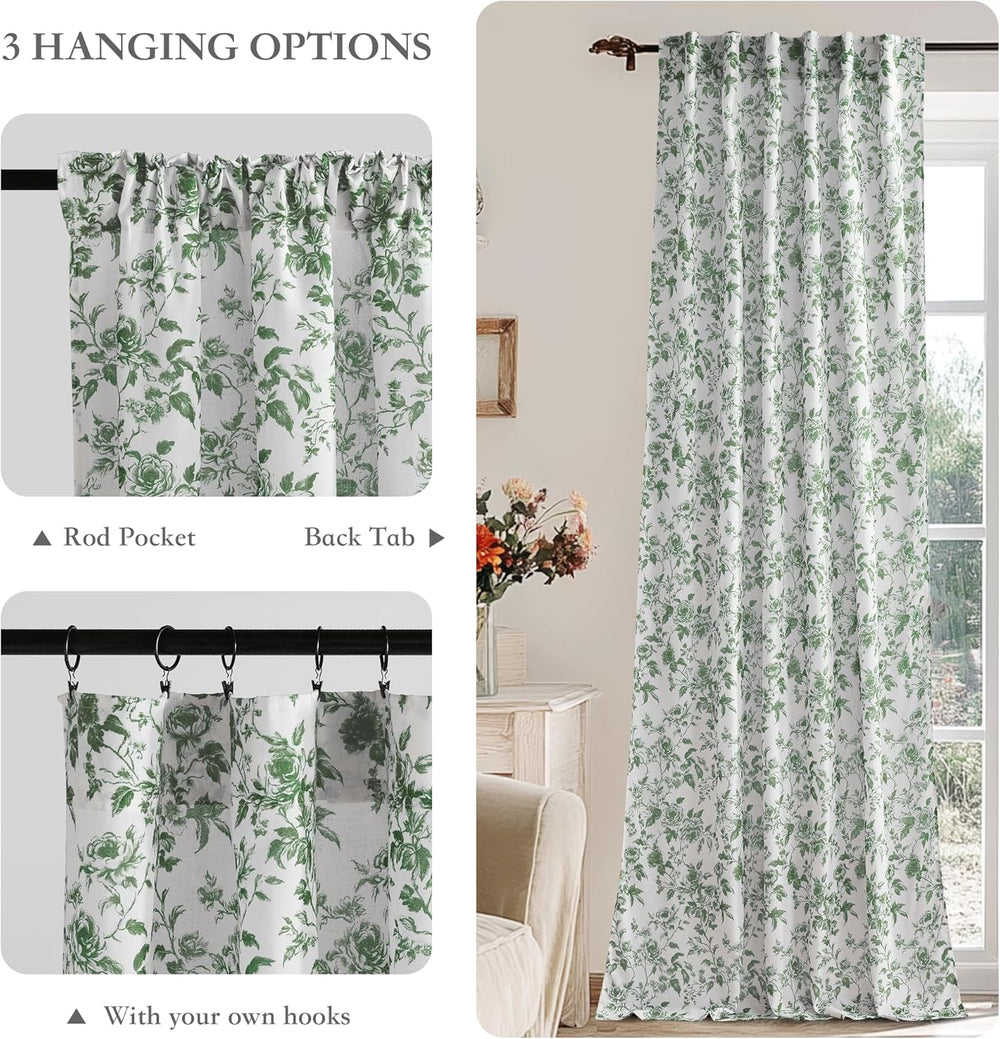 Pair of white curtains with green rose and vine floral pattern, hung on wooden rod.