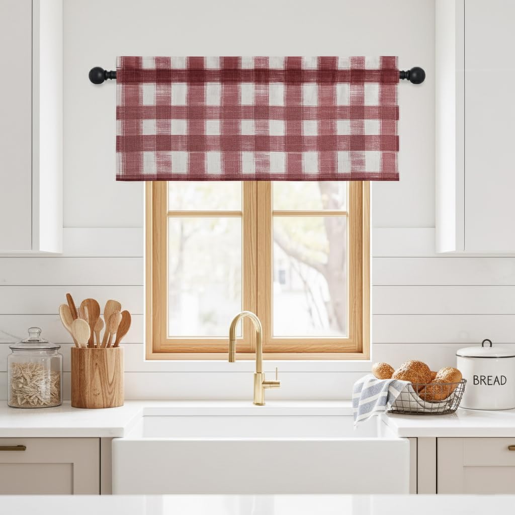 Red and white gingham rod pocket valance in a farmhouse kitchen over a sink window.