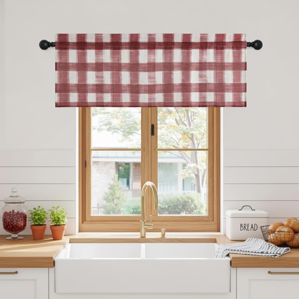 Red and white distressed buffalo check window valance hanging on a black rod in a farmhouse kitchen.