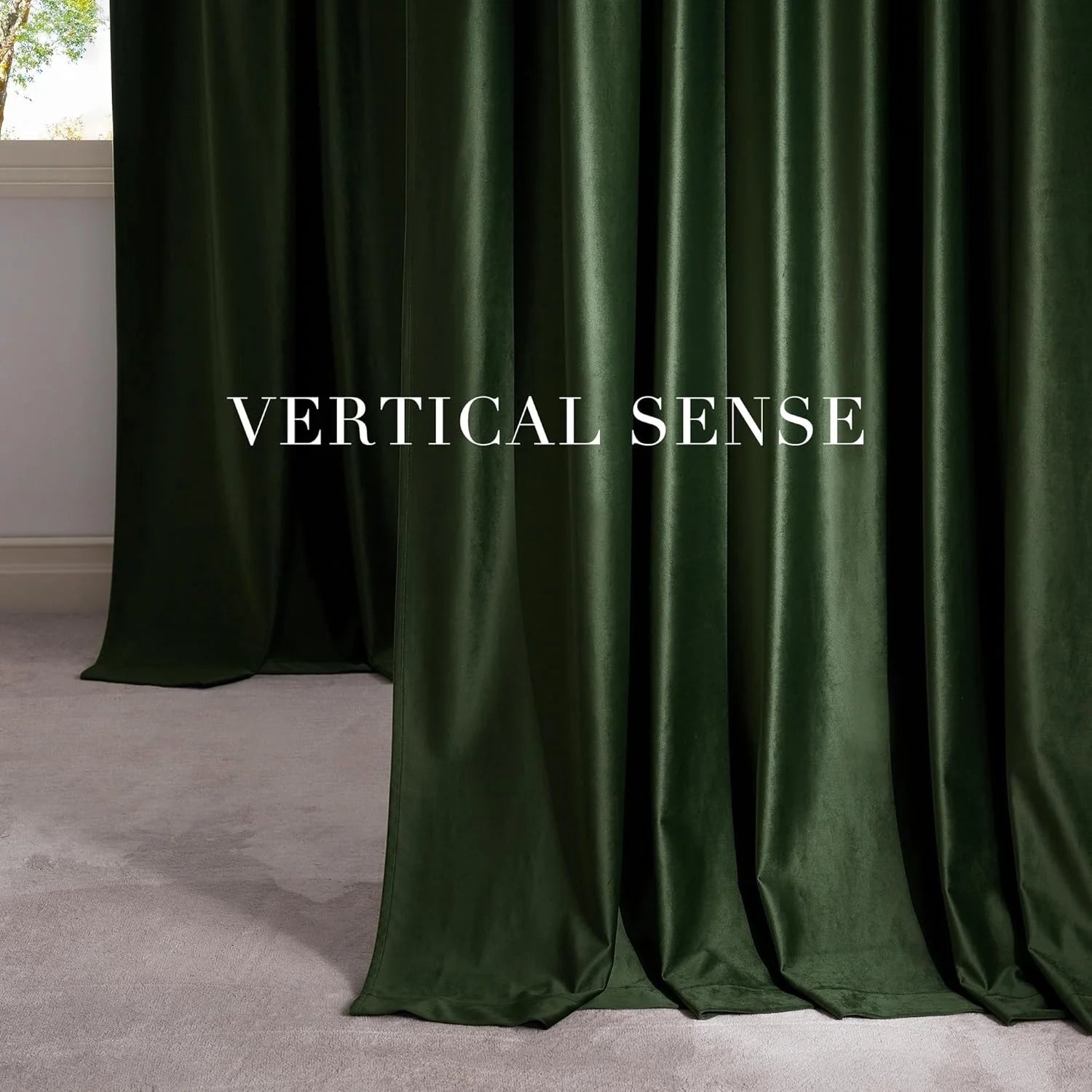 Forest green velvet curtains draping to the floor in a minimalist room