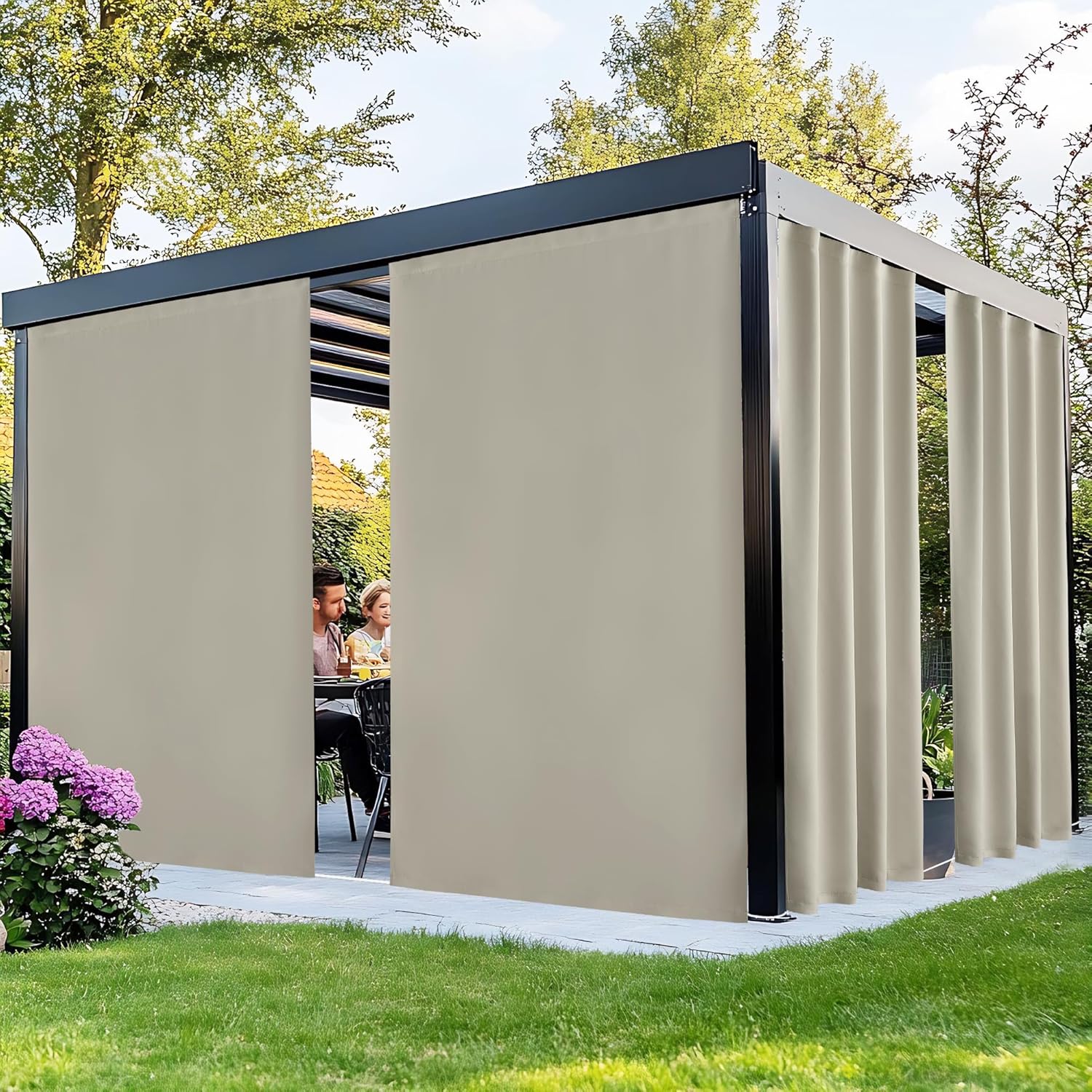 Black metal pergola with beige privacy side curtains, open, shading a couple dining in a garden.