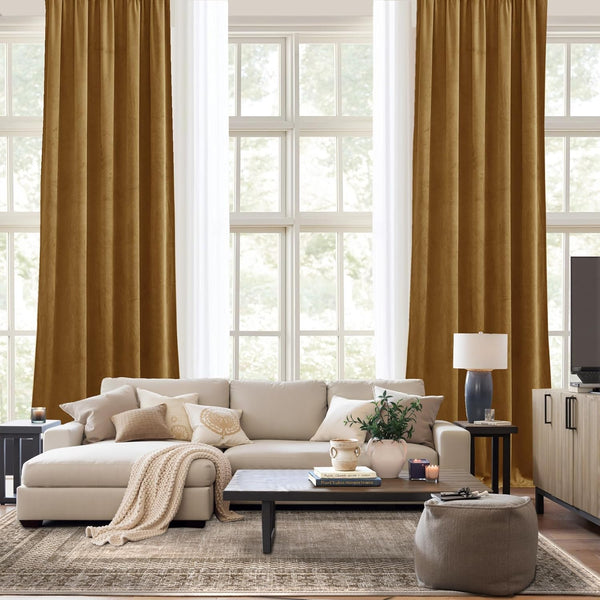 Golden brown velvet blackout curtains with rod pocket top, hanging in a bright modern living room.